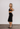 Chanel vintage knee skirt in black wool fabric with CC Chain Belt, 1998 - side profile