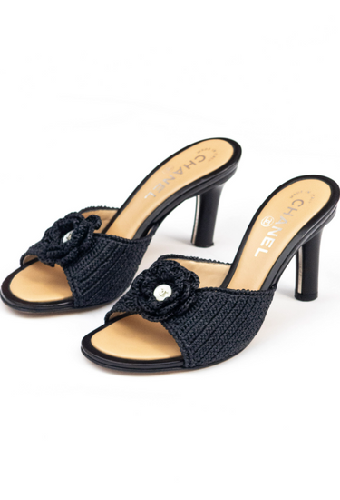 Chanel Camellia heels in black leather with crocheted raffia and CC pearl button - angled view