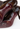 Louis Vuitton heels in chocolate hue patent leather with a ribbed wool leg warmer - back view
