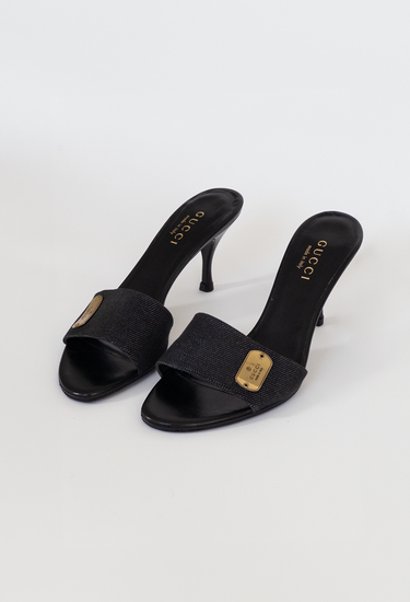 Gucci vintage denim mules in black canvas and leather with gold tone hardware - angled view