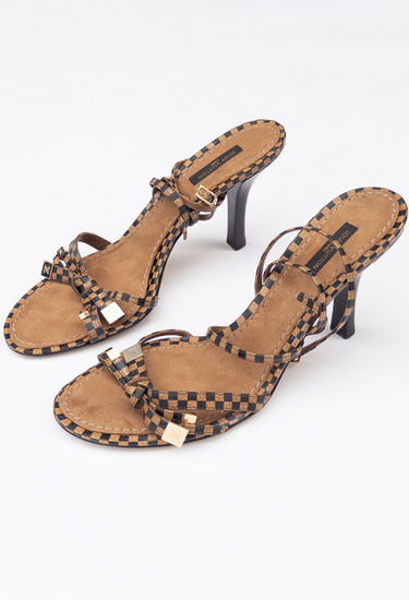 Louis Vuitton ankle strap heels in beige and brown Damier patent leather with ankle buckle and gold-tone LV cube charms - side view
