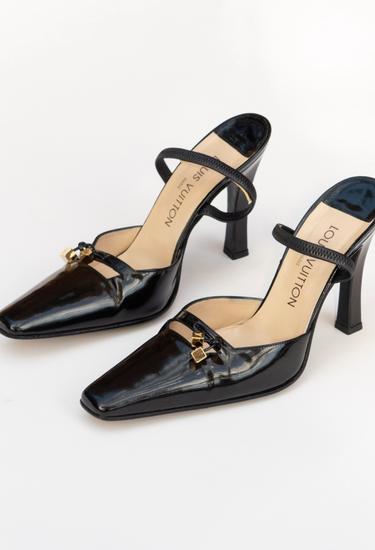 Louis Vuitton heels in black patent leather with miniature gold-tone LV cube charms - side profile