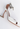 Amina Muaddi heels in white patent leather with crystal and "AWGE” logo charm - side profile