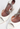 Amina Muaddi heels in white patent leather with crystal and "AWGE” logo charm - material/texture close-up