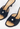 Chanel Camellia heels in black leather with crocheted raffia and CC pearl  button - material/texture close-up