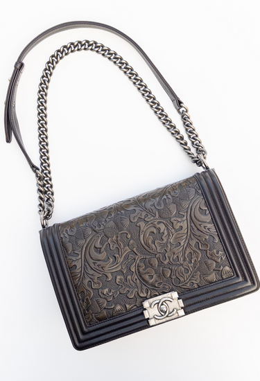 Chanel Paris-Dallas Rare Boy Embossed bag in chocolate brown leather with silver-tone clasp and chunky chain strap - angled view