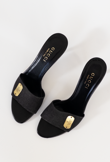 Gucci vintage denim mules in black canvas and leather with gold tone hardware - angled view