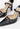 Louis Vuitton heels in black patent leather with miniature gold-tone LV cube charms - side profile