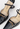Louis Vuitton heels in black patent leather with miniature gold-tone LV cube charms - material/texture close-up