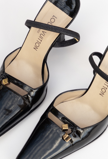 Louis Vuitton heels in black patent leather with miniature gold-tone LV cube charms - material/texture close-up