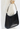 Prada oversized handle bag in black leather with silver-tone metal handle - worn/try-on view